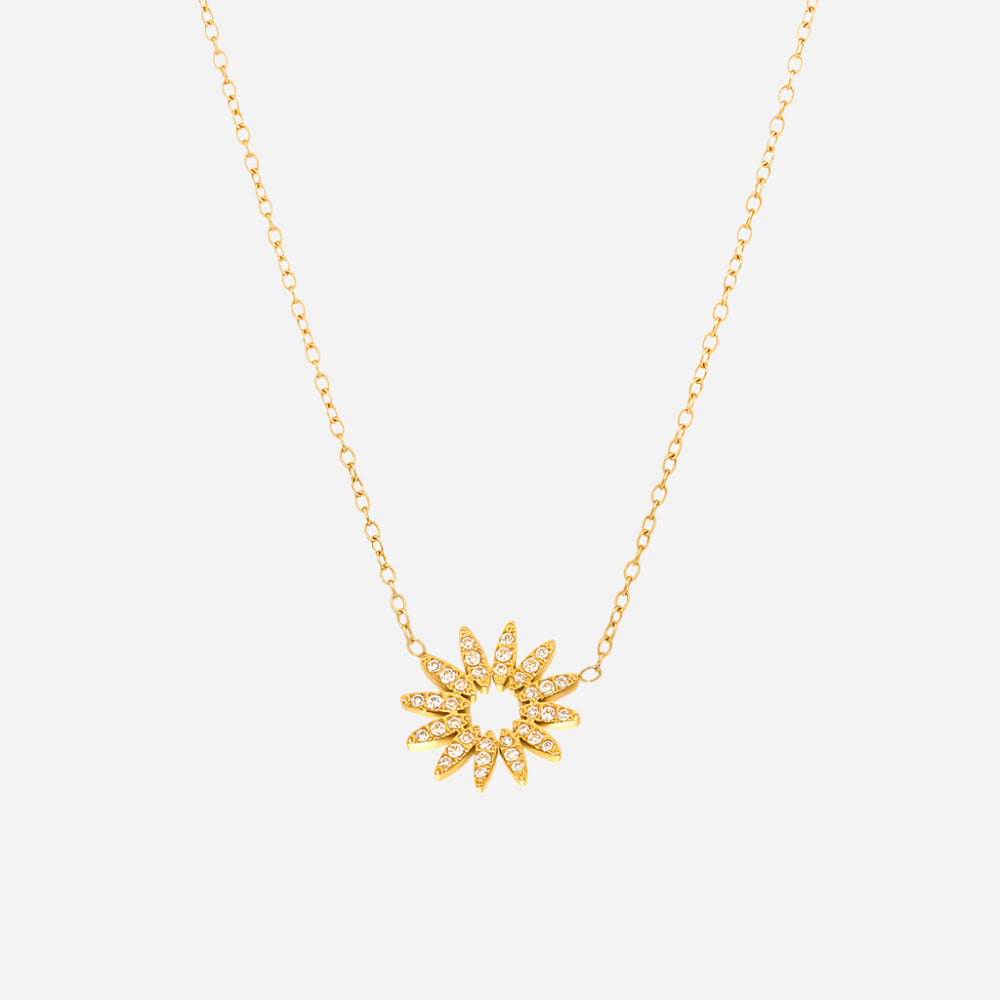 Gold sunflower charm necklace with white cubic zirconia on white background