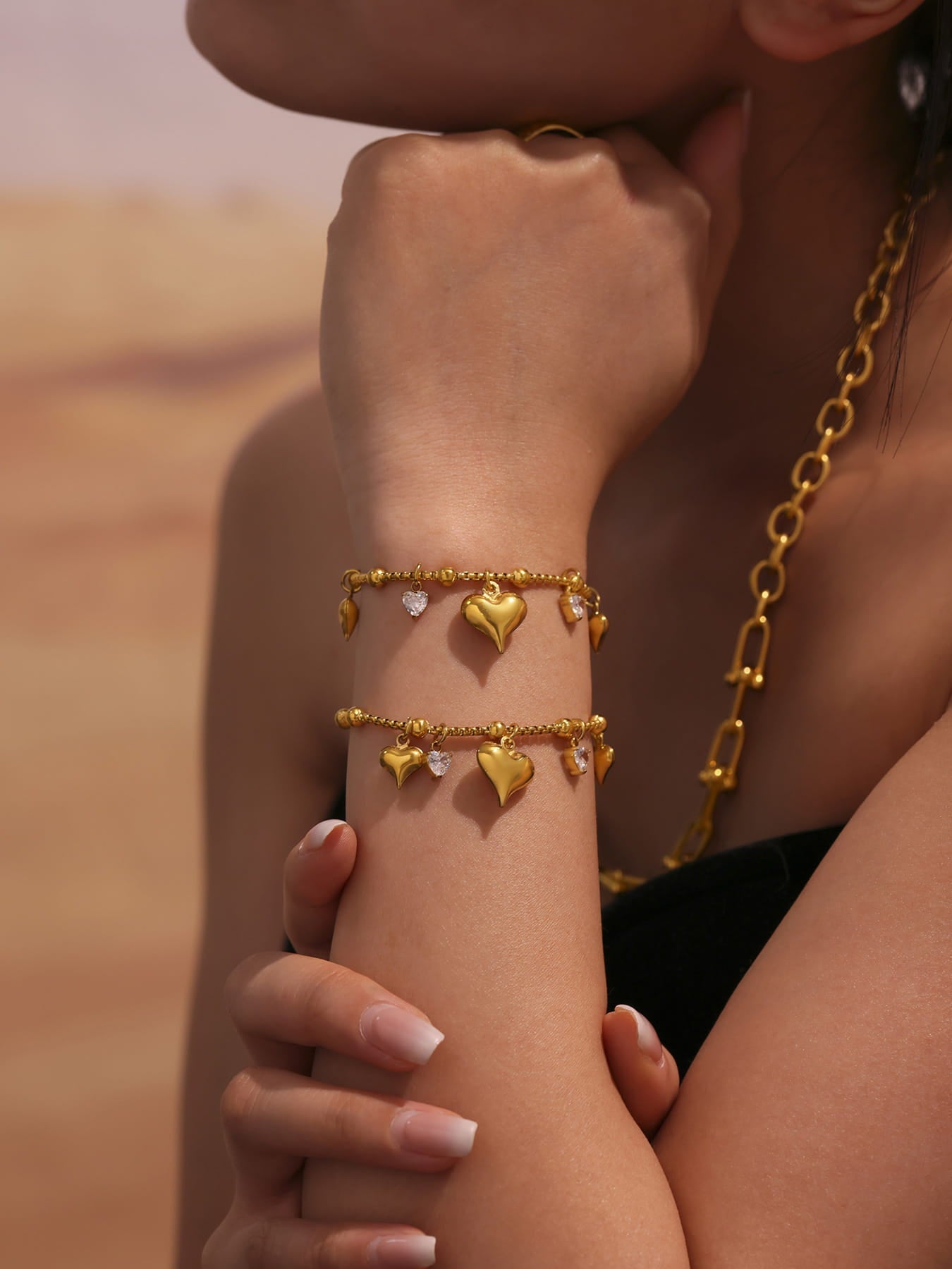 Close-up of Zircon Heart Charm Tennis Bracelet on wrist, waterproof stainless steel bangle with sparkling zircon
