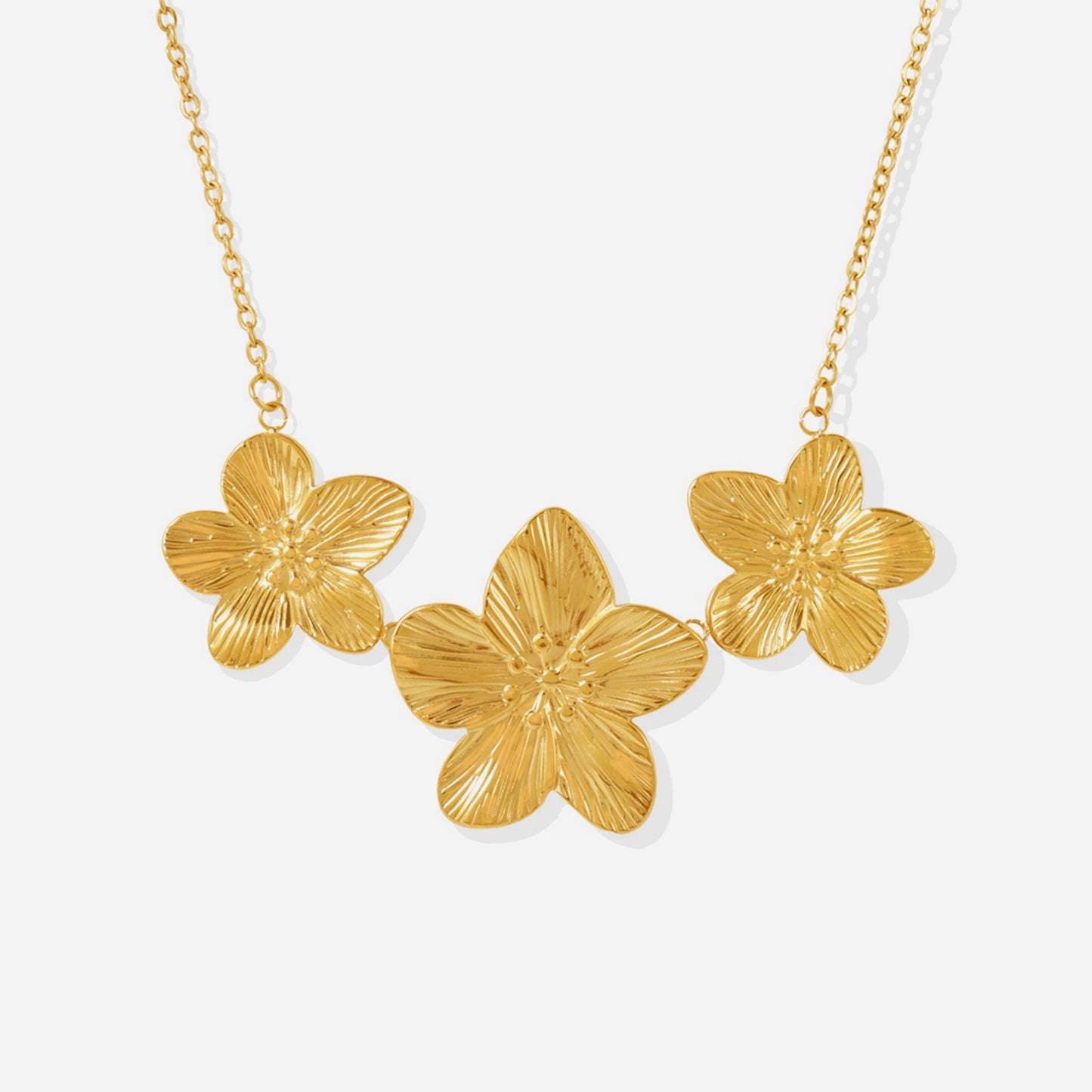 Dainty floral charm tennis necklace on white background