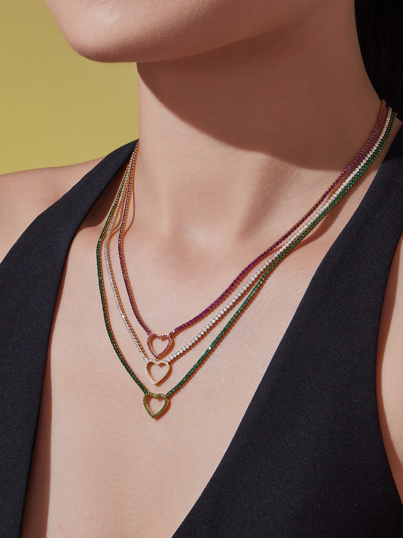 Model wearing red heart CZ tennis necklace with vibrant zircon stones on stainless steel chain