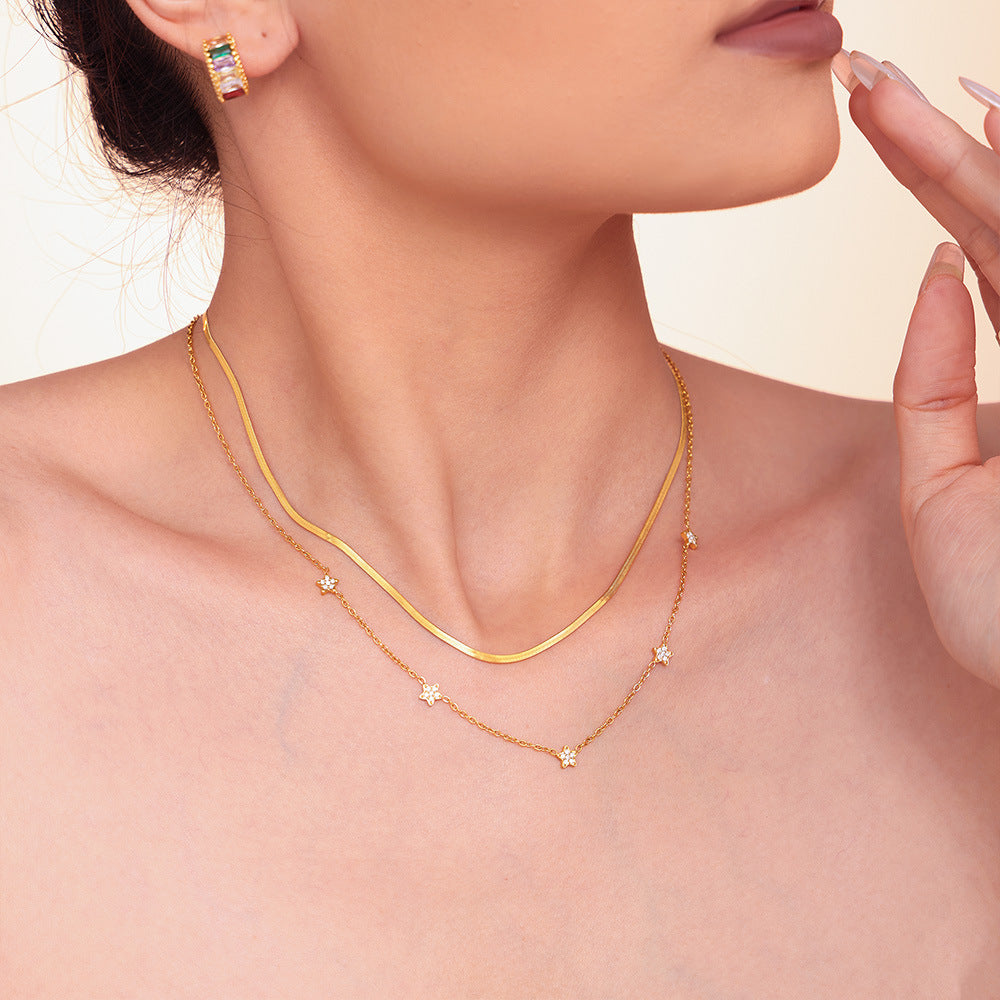 Model wearing gold five-pointed star tennis necklace – front view