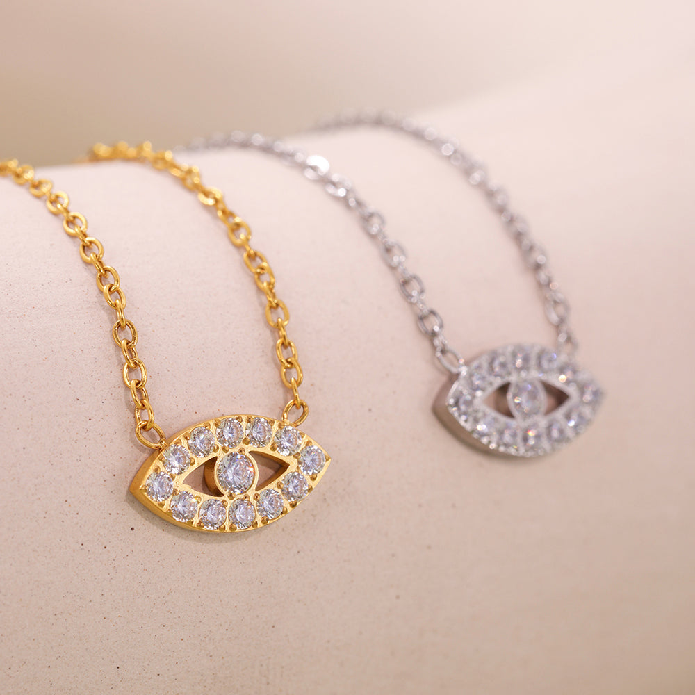 Mystic Evil Eye Bracelets with 5A Zircon in gold and steel under warm lighting, showing contrast and sparkle