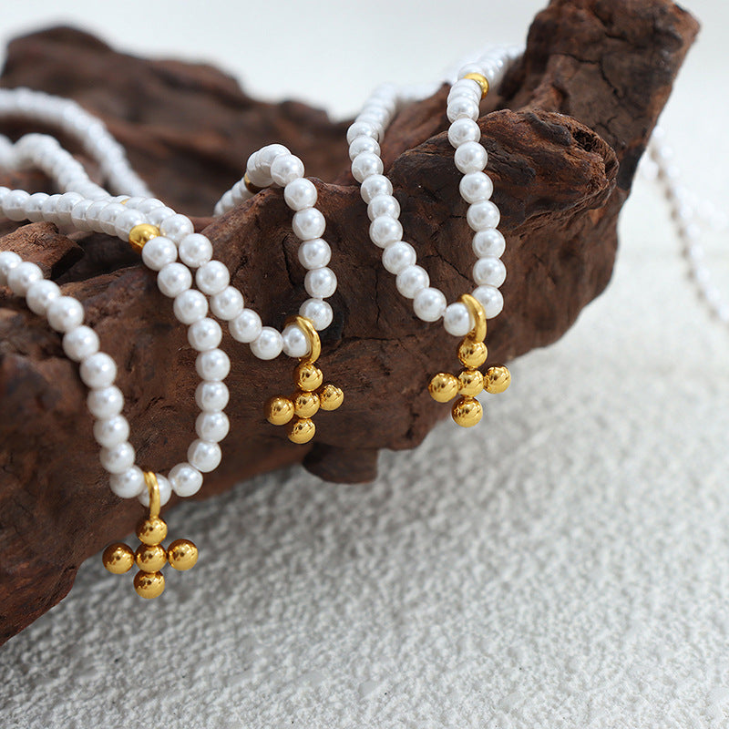 Gold Pearl Cross Pendant Necklace – Set of Three on Rustic Wooden Background