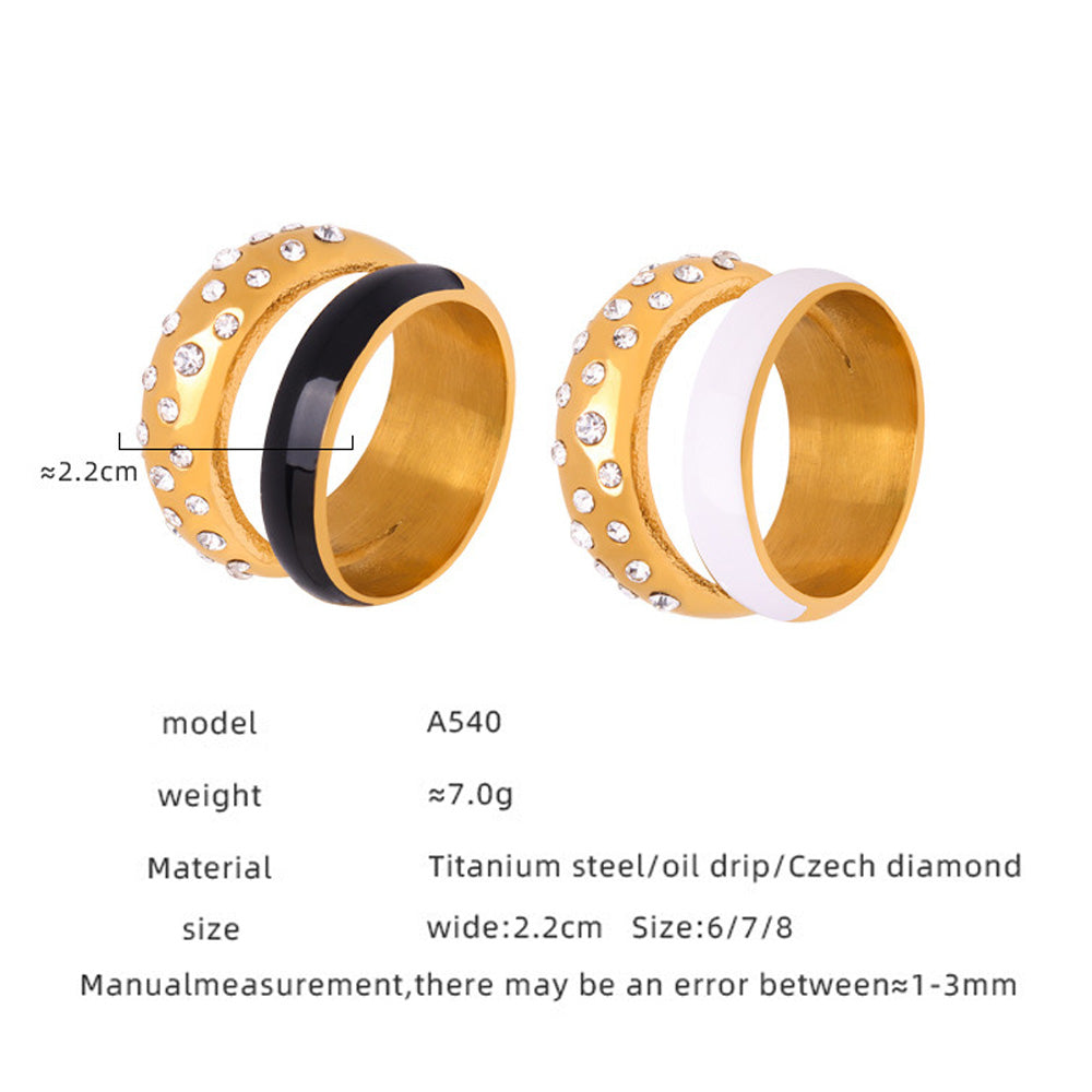 Two gold bracelets with black and white accents on a white background
