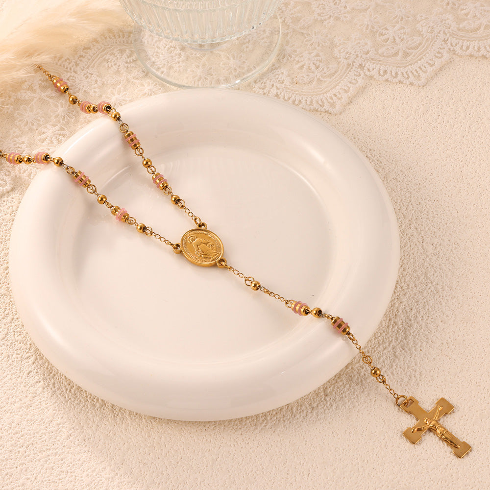 Artistic Display of Gold Tassel Cross Pendant Necklace on White Ceramic Plate