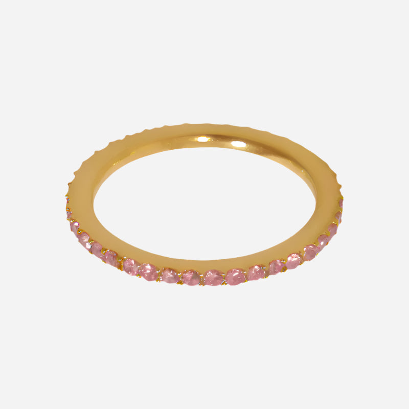 Gold ring with pink gemstones on a white background