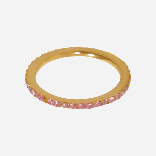 Gold ring with pink gemstones on a white background