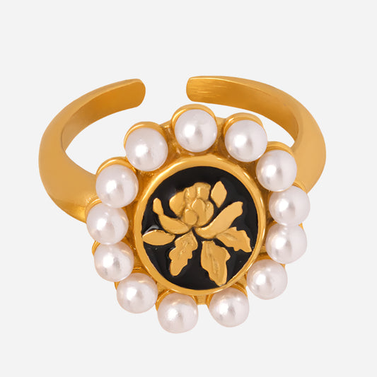 Gold-plated baroque pearl ring with sunflower floral design and geometric details on a white background
