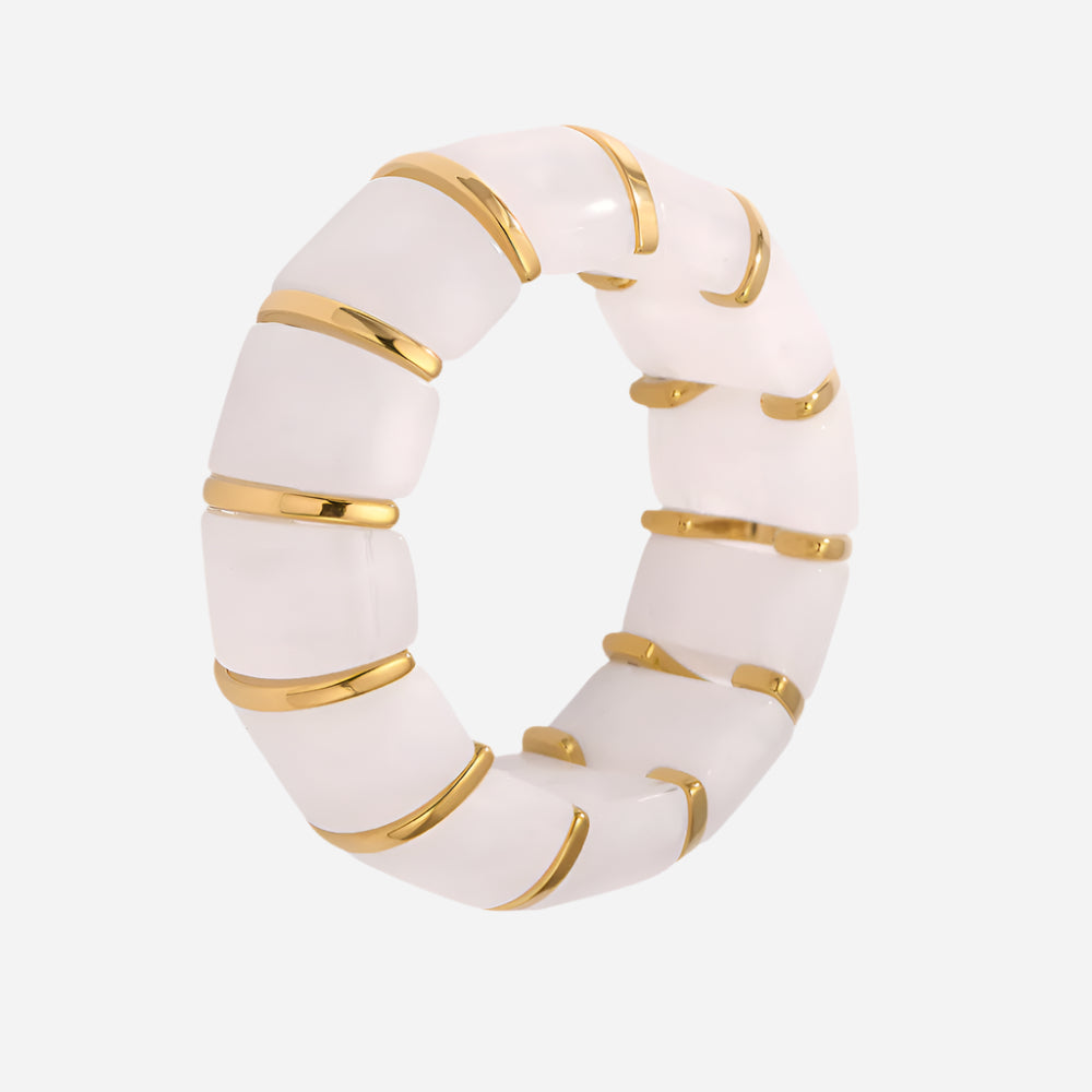 White ring with gold accents on a white background