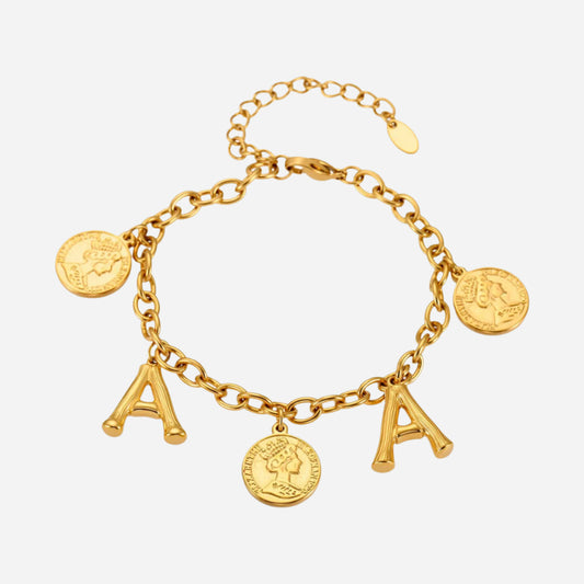 Gold bracelet with charms on a light gray background