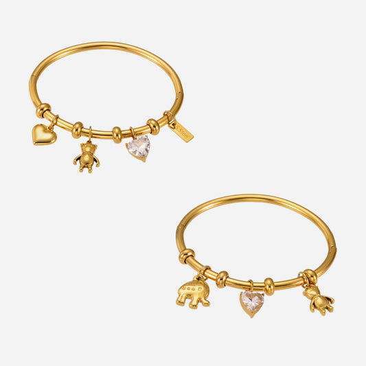 Two gold charm bangles in stainless steel with 18K gold plating on a light gray background