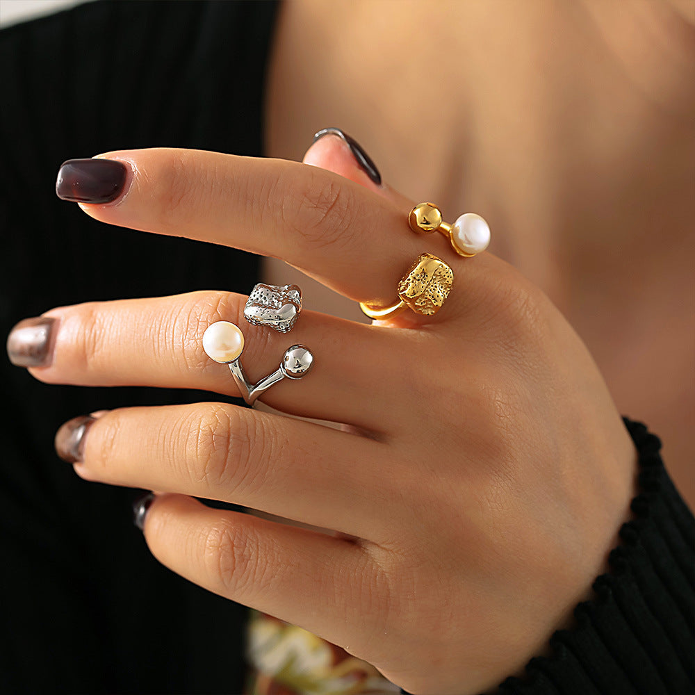 Elegant hand styling multiple freshwater pearl rings and gemstone rings for a chic layered design