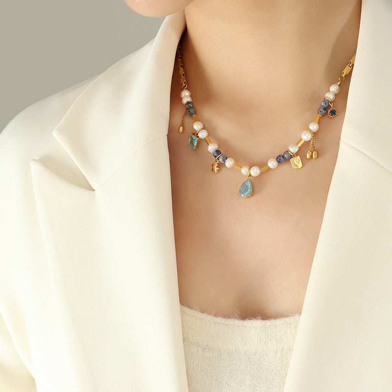 Close-up of delicate pearl choker necklace on woman’s neck