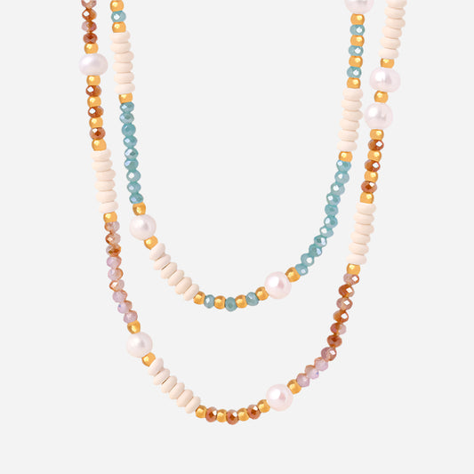 Colorful beaded necklace with freshwater pearls on white background