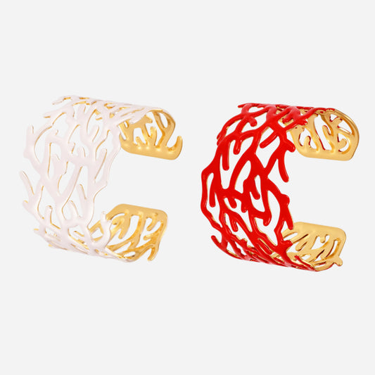Coral red bracelet and white stainless steel bangle with gold accents on a light gray background