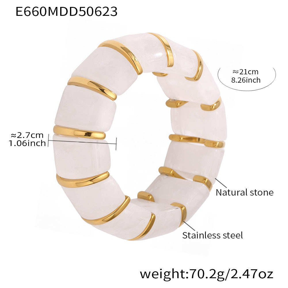 White ring with gold accents and measurements on a white background