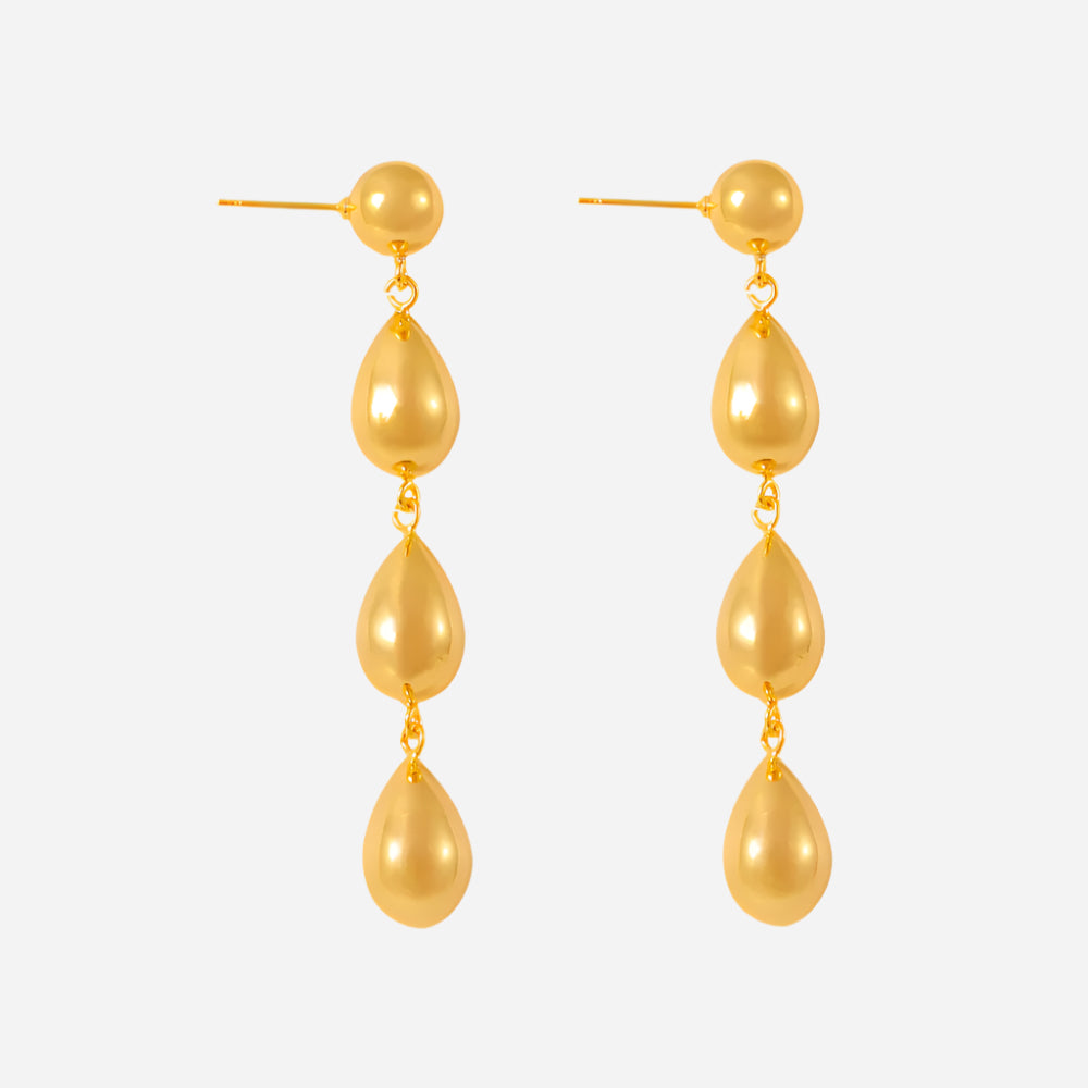 Gold teardrop earrings on a white background