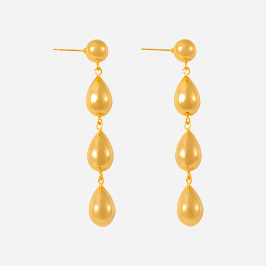 Gold teardrop earrings on a white background
