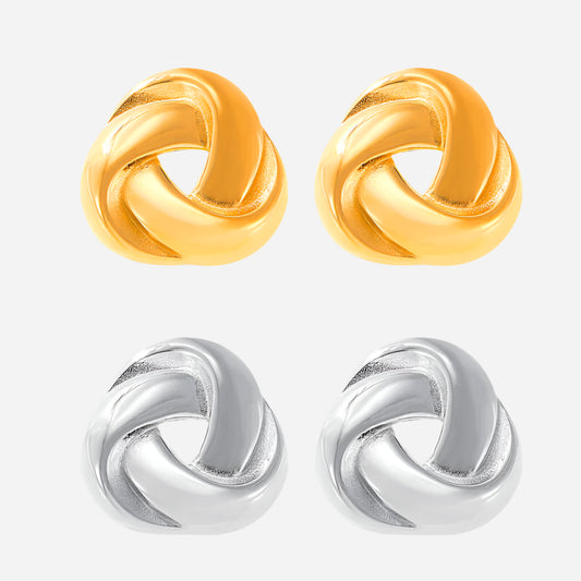 Pair of gold and silver knot-shaped earrings on a white background