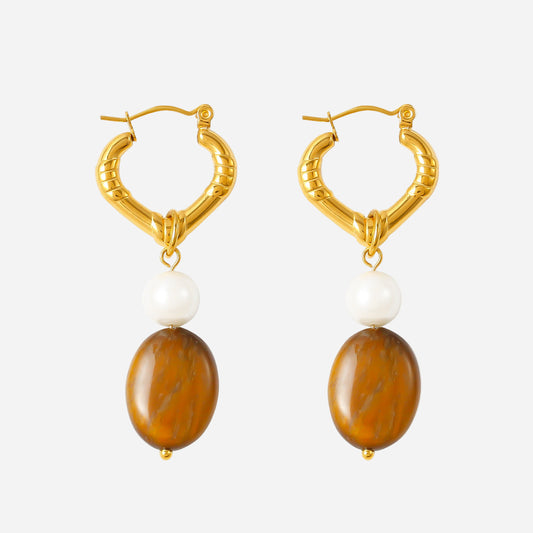 Gold hoop earrings with brown beads and white stones on a white background