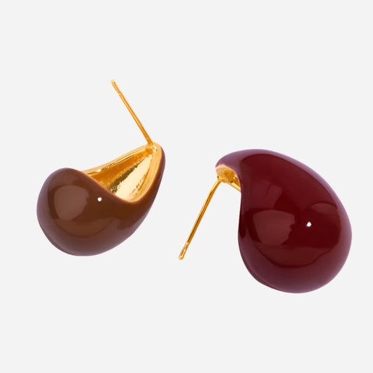 Teardrop-shaped earrings with gold and brown finish on a white background