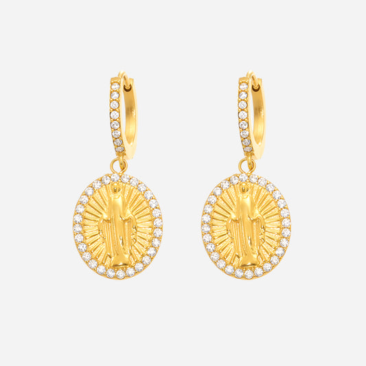 Gold earrings with religious design on a white background