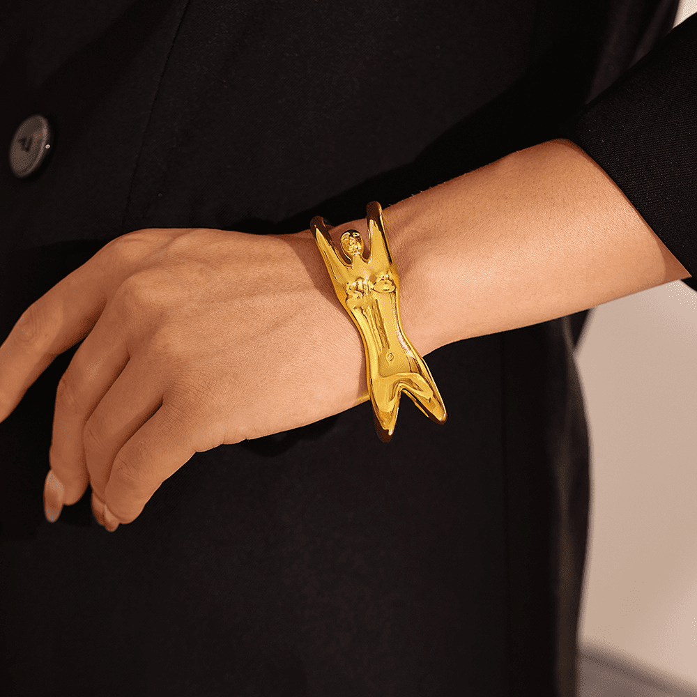 Model wearing 18K gold tennis bracelet with elegant ridged design