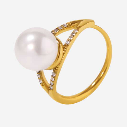 Gold ring featuring a large pearl and small diamond accents on a clean white background