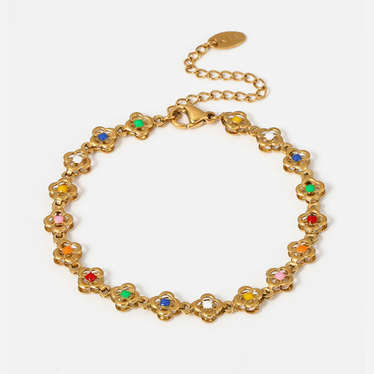 Floral mini tennis bracelet in gold on white background
