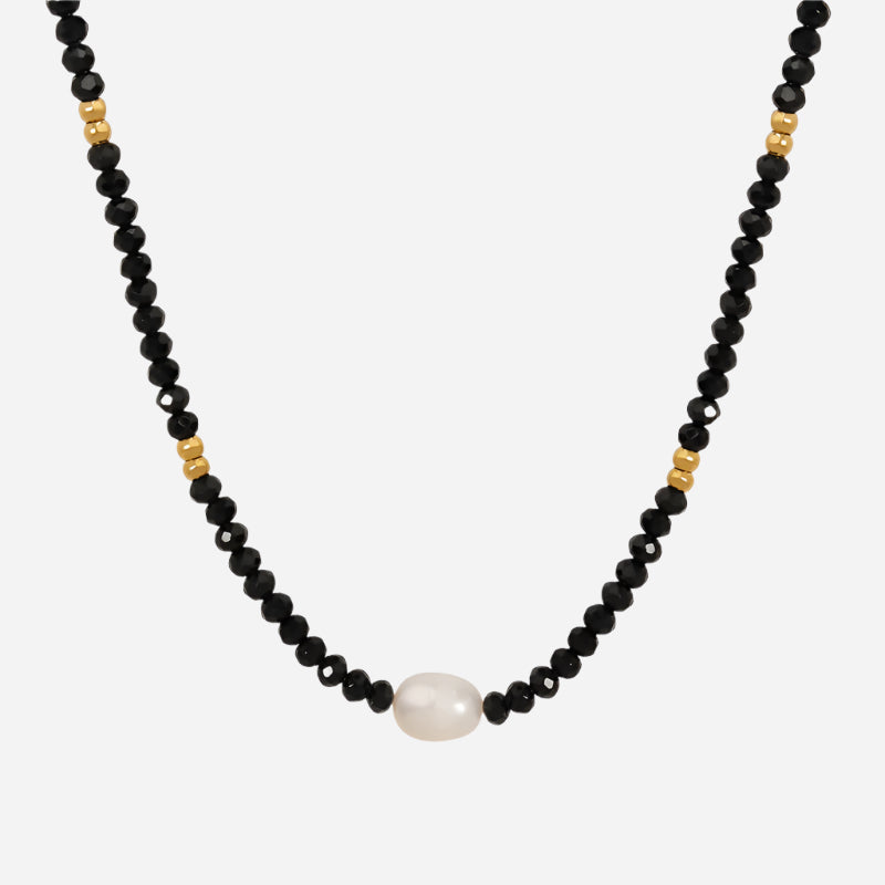 Black beaded necklace with freshwater pearl pendant on white background