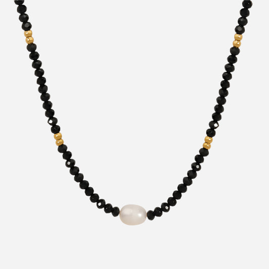 Black beaded necklace with freshwater pearl pendant on white background