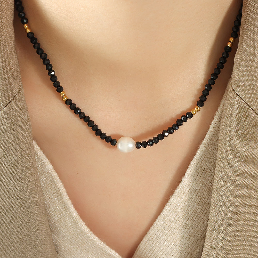 Close-up of freshwater pearl drop necklace worn by model