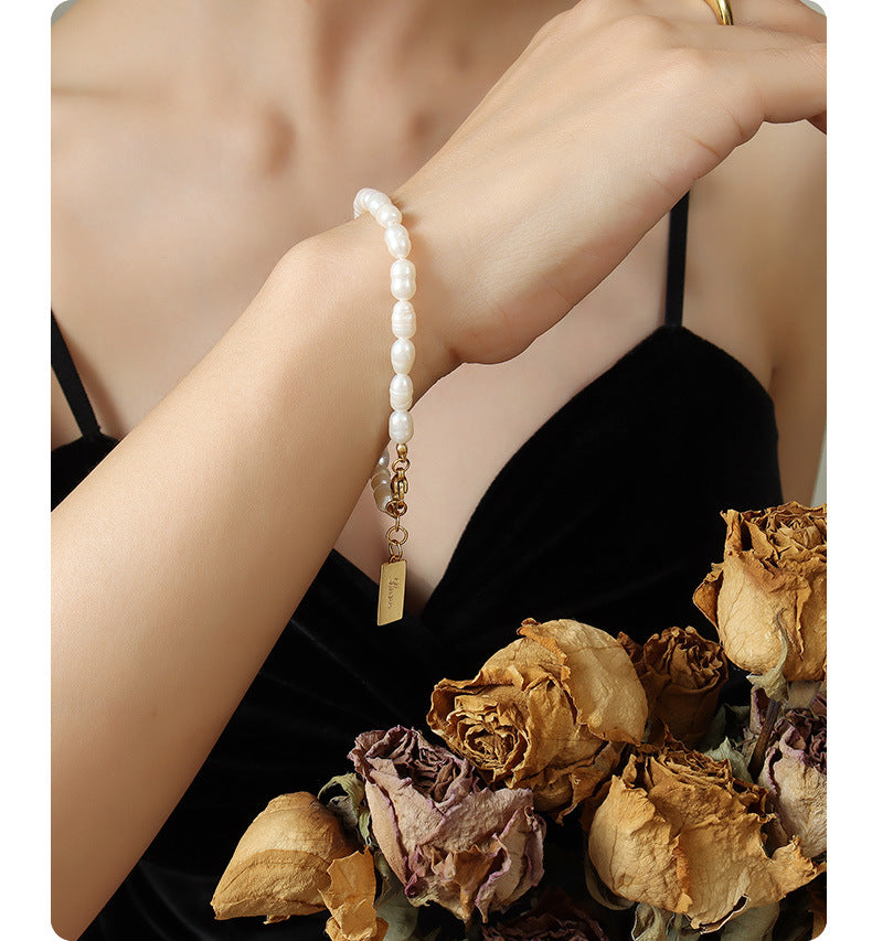 Gold waterproof pearl bracelet styled on model with casual summer outfit