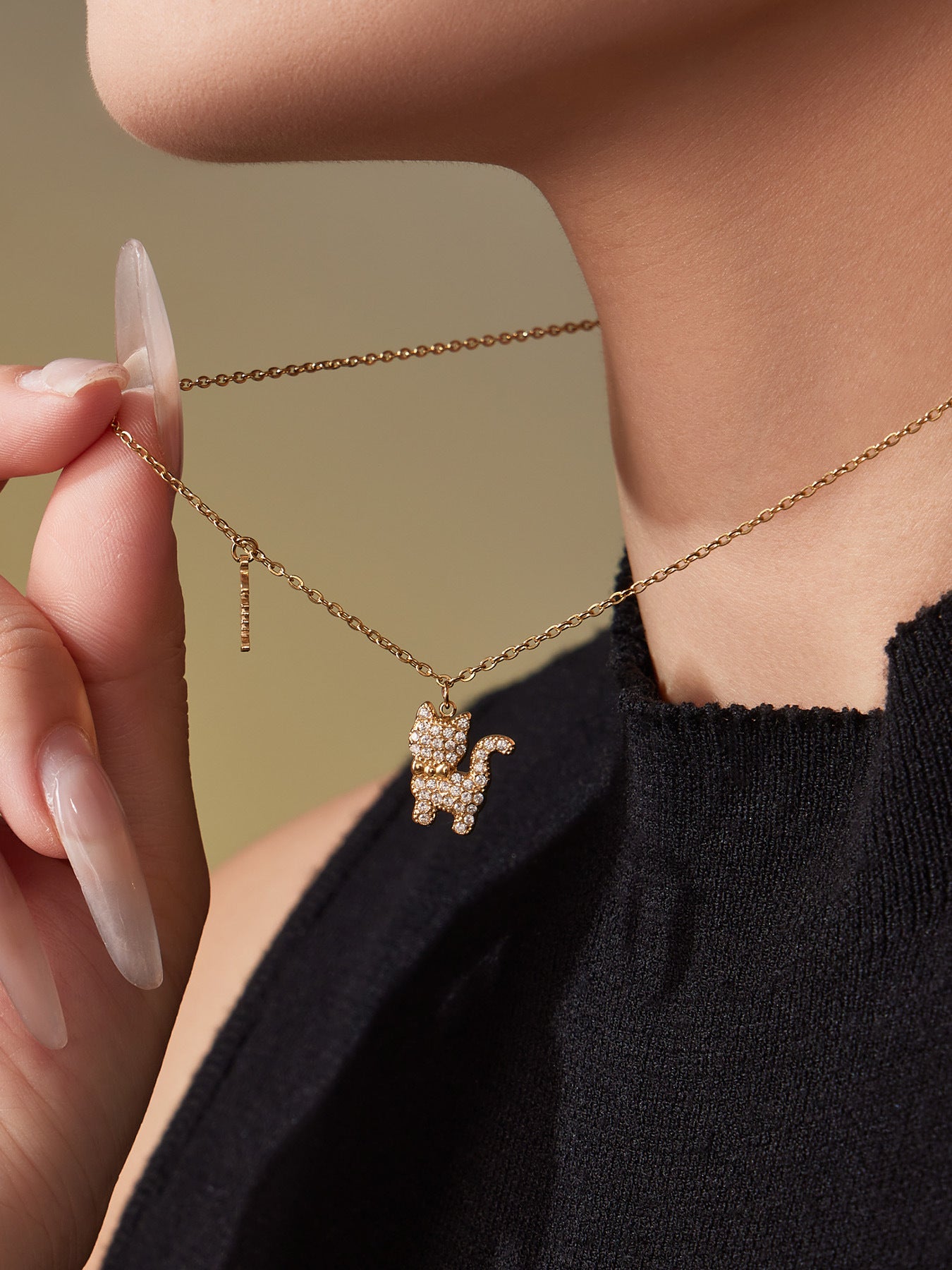 Model wearing the gold CZ cat necklace, showing the dainty pendant resting at the collarbone.