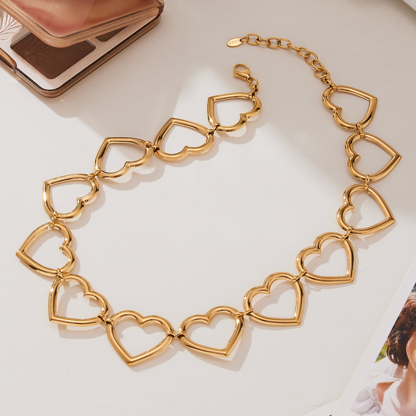 Close-up of gold linked heart chain necklace