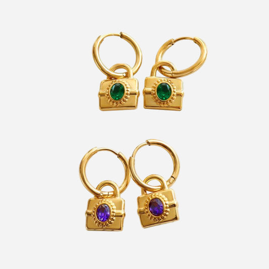 Gold padlock hoop earrings with green and purple gemstone charms shown on a clean white background.