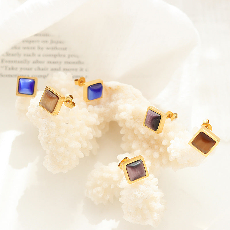 Set of three square cat eye stud earrings in gold stainless steel on pearl background, waterproof and hypoallergenic minimalist earrings