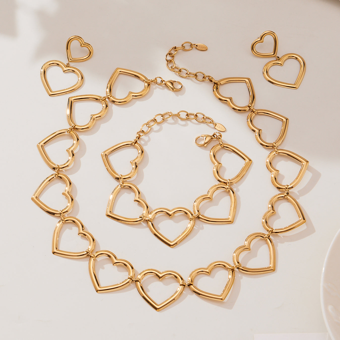 Gold heart chain necklace laid out in circular shape