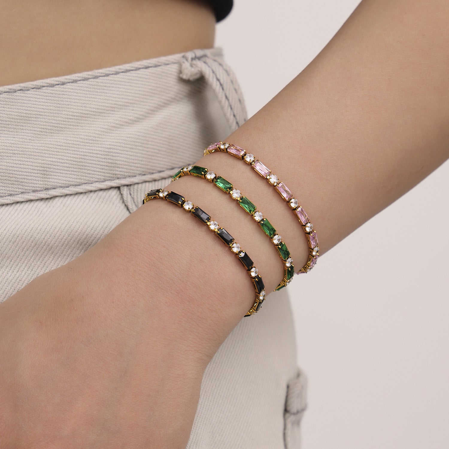 Close-up of layered beaded bracelets worn on wrist – gold clasp multicolor jewelry