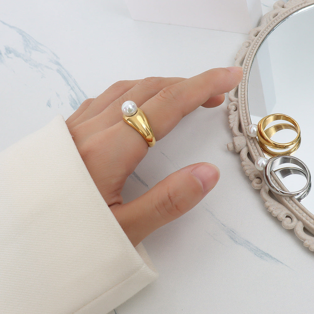 Woman wearing adjustable gold pearl ring – waterproof and hypoallergenic statement jewelry