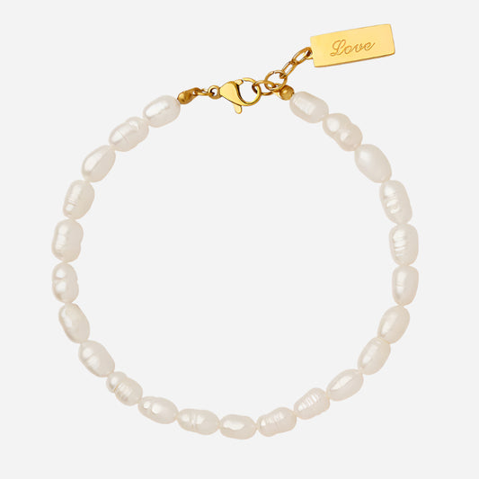 White background view of gold waterproof love pearl bracelet for women