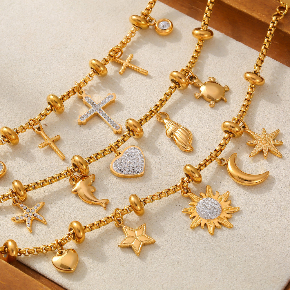 Gold waterproof bracelet with mixed symbolic charms on a clean white background