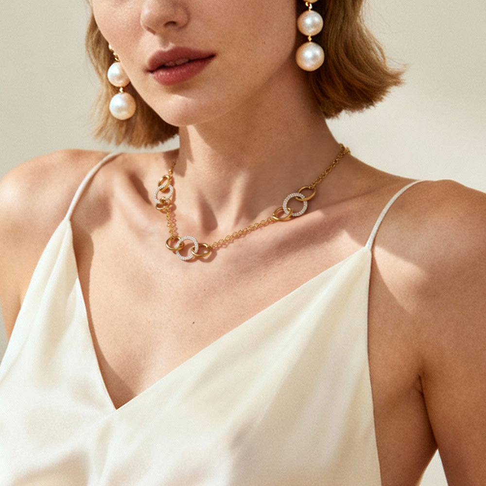 Model wearing 18K gold diamond circle necklace, elegant layered look with deep V dress
