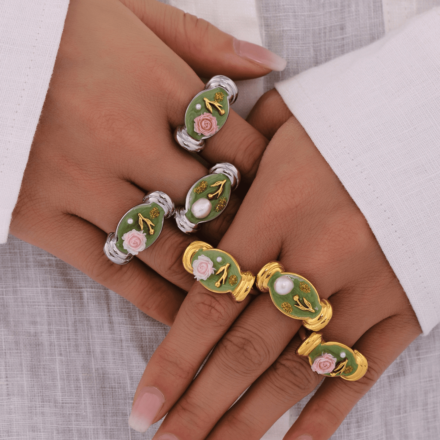A model wearing a gold and steel chunky silver ring, showcasing a stylish jewelry combination.