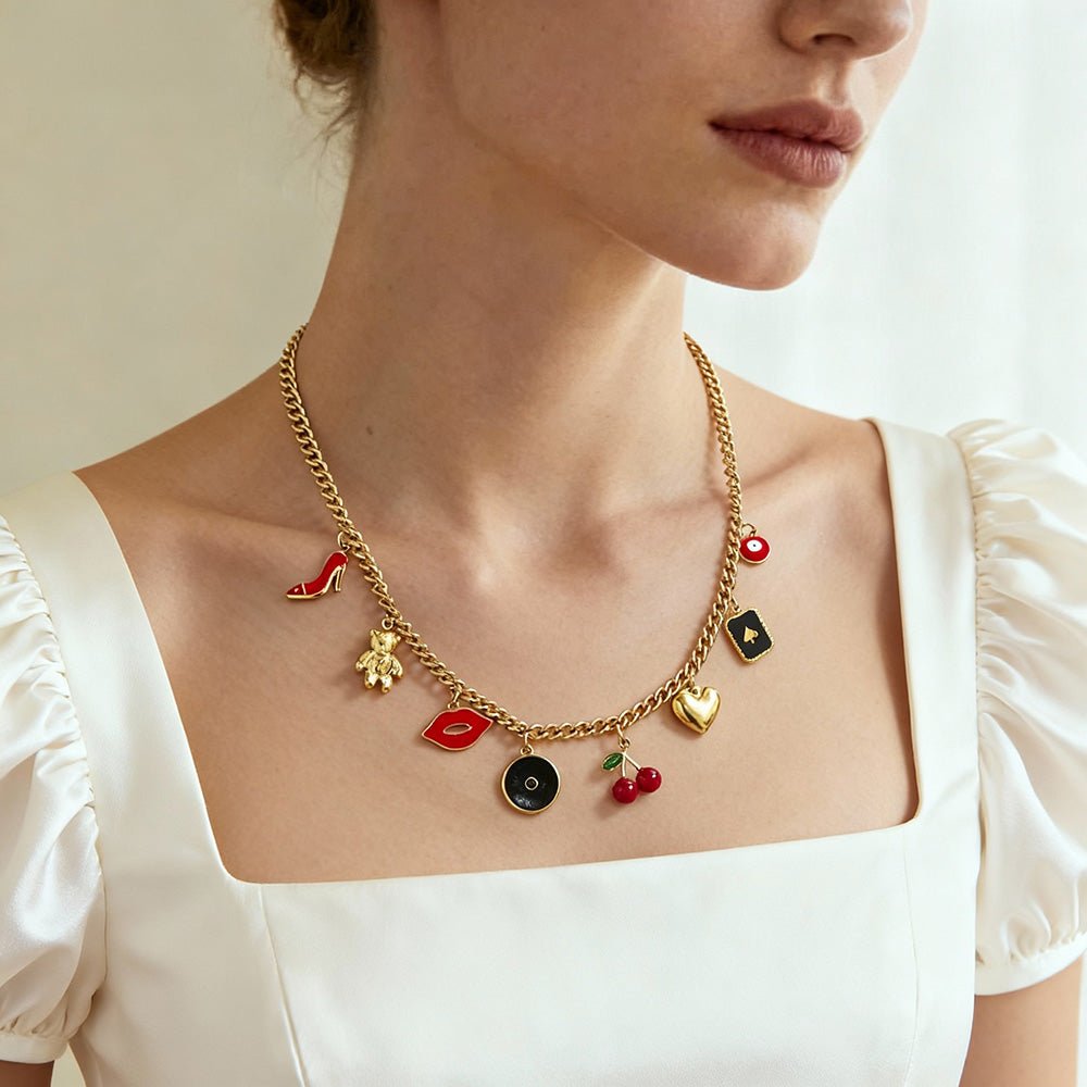 Model wearing vintage gold charm necklace with cherry and heart pendants, feminine romantic jewelry style