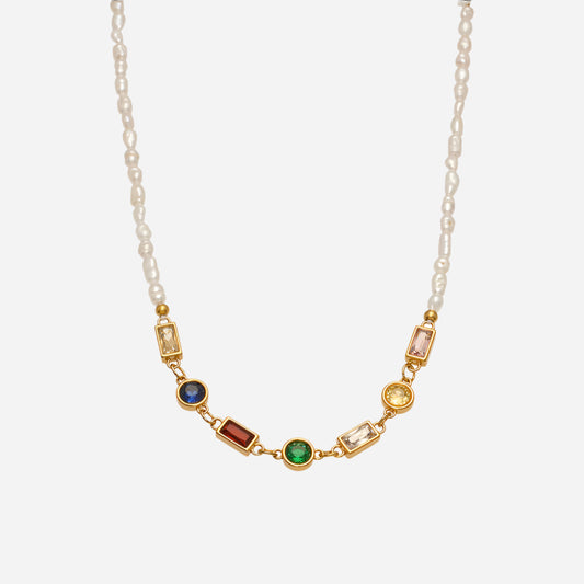 Necklace with gold chain and colorful gemstones on a white background