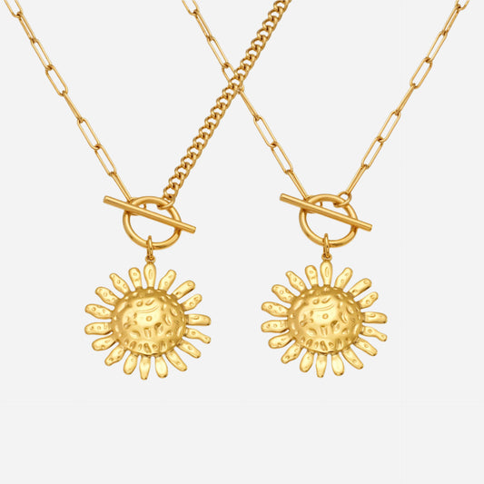 Two gold necklaces with sun-shaped pendants on a white background
