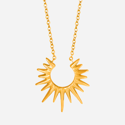 Gold sun-shaped pendant necklace on a white background