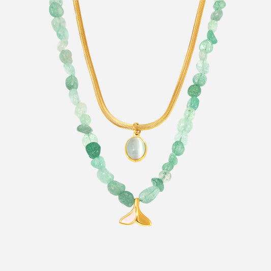 Two green beaded necklaces with gold accents on a white background