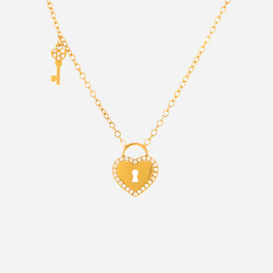 Gold necklace with heart-shaped lock pendant and key charm on a white background